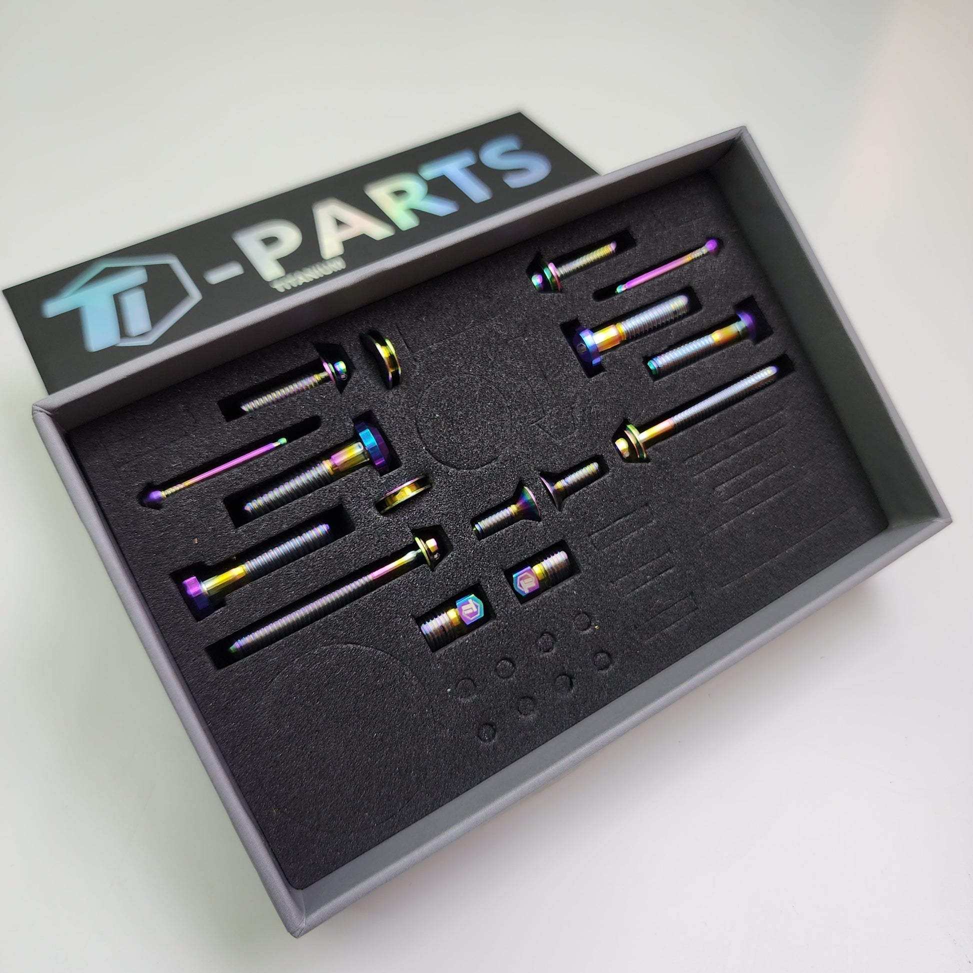 Rainbow oil-slick titanium SRAM brake upgrade kit in display tray