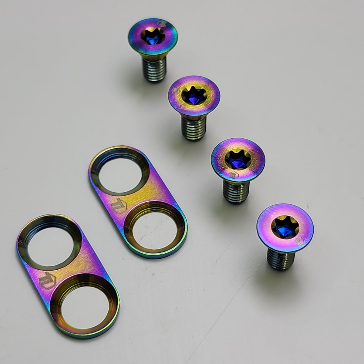 Oil-slick titanium cleat bolts and plates for Shimano SPD cleats