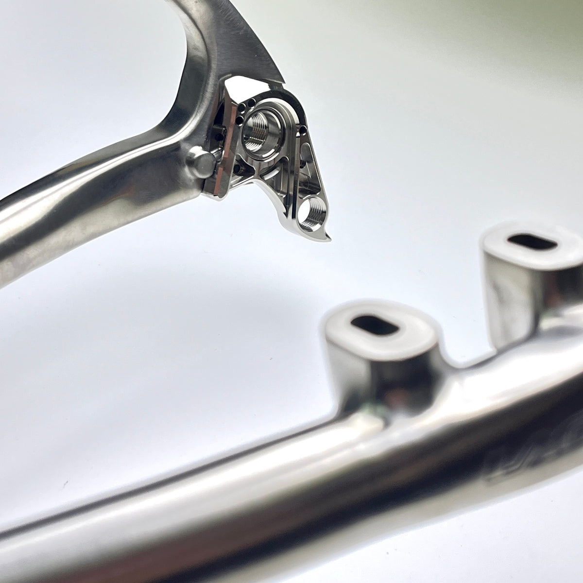 Hot Check x TiParts Titanium Universal Rear Derailleur Hanger (UDH RD Hanger) | Shimano & SRAM