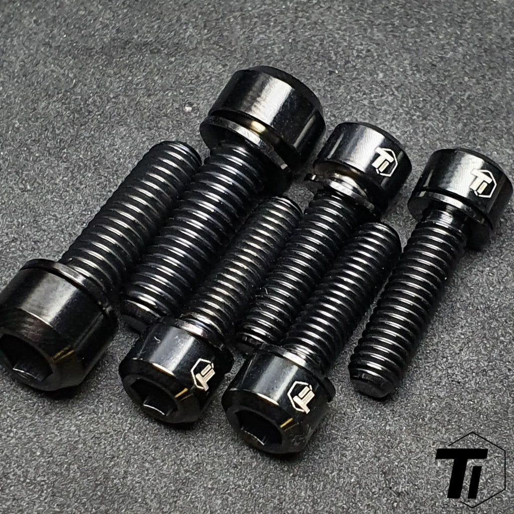 Close-up arrangement of black titanium Specialized Trail 35 mm stem bolts